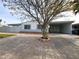 Front yard view of a single-story house with brick and a tree at 2640 Donna St, North Las Vegas, NV 89030