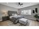 Main bedroom with tufted headboard and ceiling fan at 2895 Sunlit Glade Ave, Henderson, NV 89074