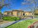 Single-story home with a modern design, landscaped lawn, and a large garage at 309 Rosegate Ave, Henderson, NV 89052