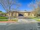 Modern single-story house with a neutral color palette, landscaped yard, and attached garage at 309 Rosegate Ave, Henderson, NV 89052