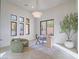 Sunlit home office with herringbone floors, a large desk, and modern chandelier at 309 Rosegate Ave, Henderson, NV 89052