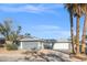 House exterior features gray paint, a two-car garage, and desert landscaping at 4300 El Esteban Way, Las Vegas, NV 89121