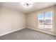 Bedroom with carpeted floors and a window offering street views at 4389 Bluecrest Rd, Las Vegas, NV 89121