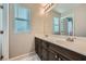 Bathroom with double sinks, dark wood cabinets, and a vanity at 5096 Green Hollow St, North Las Vegas, NV 89031