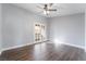 Bright bedroom with wood-look flooring and French doors leading to a balcony at 511 Bass Dr # C, Henderson, NV 89014