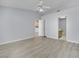 Bright bedroom featuring gray walls, wood-look floors, and a ceiling fan at 5125 Briar Meadow Way, Las Vegas, NV 89118