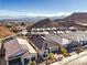 Aerial view of houses with solar panels, mountain views, and desert landscape at 56 Tatahatso Point St, Henderson, NV 89011