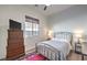 Charming bedroom with a metal bed frame and dresser at 56 Tatahatso Point St, Henderson, NV 89011