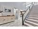 Bright entryway with a statement cabinet and staircase at 5633 Silver Cascade Ave, Las Vegas, NV 89131