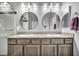 Double vanity bathroom with granite countertops and large mirrors at 5732 Swan Bridge St, North Las Vegas, NV 89081