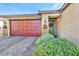 Single-story home with landscaped front yard, red door, and two-car garage at 5732 Swan Bridge St, North Las Vegas, NV 89081