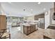 Open concept kitchen with island, stainless steel appliances and view into living room at 5732 Swan Bridge St, North Las Vegas, NV 89081