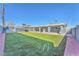 Large backyard with artificial turf and covered patio at 6429 Evergreen Ave, Las Vegas, NV 89107