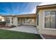 Covered patio with adjacent grass and shrubs at 10242 Largo Sassetta Ct, Las Vegas, NV 89135