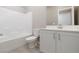 Bathroom with tub, toilet and white vanity at 11431 Gravitation Dr # 102, Las Vegas, NV 89135