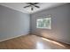 Light and airy bedroom with wood flooring and a ceiling fan at 3761 Tranquility Ridge Ct, Las Vegas, NV 89147