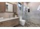 Modern bathroom with a walk-in shower and pebble floor at 40 Chalet Hills Ter, Henderson, NV 89052