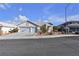 Two-car garage and front yard with desert landscaping at 694 Riverband Pl, Henderson, NV 89052