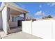 Covered patio with white fence and gray curtains at 694 Riverband Pl, Henderson, NV 89052