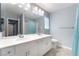 Double sink bathroom with light teal accents at 9883 Russian Hill St, Las Vegas, NV 89141