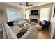 Light and airy living room, featuring a stone fireplace and comfortable seating at 10478 Melodia Magico Ave, Las Vegas, NV 89135