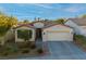 Single-story house with a two-car garage and landscaped front yard at 10525 Shanna Trellis Ave, Las Vegas, NV 89144