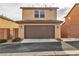 Two-car garage with brown door and exterior lighting at 10731 Mason Hill Ave, Las Vegas, NV 89166