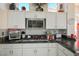 White kitchen with granite countertops and modern appliances at 11008 Mission Lakes Ave, Las Vegas, NV 89134