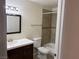 Updated bathroom with dark brown vanity and tile flooring at 1150 N North Buffalo Dr. Dr # 1076, Las Vegas, NV 89128