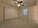 Bright bedroom with tile flooring, large closet, and ceiling fan at 1150 N North Buffalo Dr. Dr # 1076, Las Vegas, NV 89128