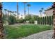 Backyard with stone path, lush lawn and palm trees at 2134 Inverness Dr, Henderson, NV 89074