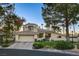 Single-story house with a tile roof, landscaped yard, and two-car garage at 2134 Inverness Dr, Henderson, NV 89074