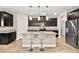 Modern kitchen with dark cabinetry, granite counters, and an island with seating at 2238 Thelen Ave, North Las Vegas, NV 89086