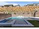 Resort-style pool and spa with a water feature and basketball court backdrop at 437 Cascade Heights Ave, Las Vegas, NV 89138