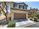 Two-story house with a brown garage door at 4977 Crimson Mare Rd, Las Vegas, NV 89139