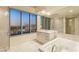 Luxurious bathroom with soaking tub, walk-in shower, and city views at 222 Karen Ave # 1702, Las Vegas, NV 89109