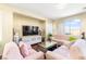 Living room with hardwood floors, pink sofas, and large TV at 2795 Murray Hill Ln, Las Vegas, NV 89142