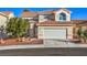 Two-story house with a large garage and well-manicured landscaping at 3304 Oeste Vista St, Las Vegas, NV 89129