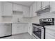 Bright kitchen with white cabinets, stainless steel appliances, and quartz countertops at 4432 Halbert Ave, Las Vegas, NV 89110