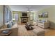 Virtually staged living room with fireplace and wood floors at 6086 Shadow Oak Dr, North Las Vegas, NV 89031