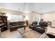 Spacious living room with leather furniture and a large TV at 7253 Sterling Rock Ave, Las Vegas, NV 89178