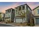 Three-story house with gray siding, blue shutters, and a balcony at 8040 Mercury Skye St, Las Vegas, NV 89166