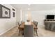 Spacious dining area with a long wooden table and gray fabric chairs at 8937 Pelican Point St, Las Vegas, NV 89178