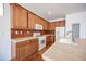 View of kitchen with wood cabinets and tile backsplash at 9343 Oxbow Lake Ave, Las Vegas, NV 89149