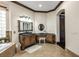 Bathroom with corner vanity and dark wood cabinets at 10254 Sofferto Ave, Las Vegas, NV 89135