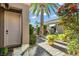 Charming courtyard entry with mature palm trees and stone pathway at 10254 Sofferto Ave, Las Vegas, NV 89135