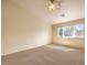 Bright bedroom with carpeted floor, large window, and ceiling fan at 10319 Birch Bluff Ln # 0, Las Vegas, NV 89145