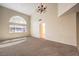 Bright living room with high ceilings, large windows, and chandelier at 10319 Birch Bluff Ln # 0, Las Vegas, NV 89145