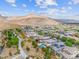 Aerial view of houses, community park, and mountain views at 10554 Cloud Whisper Dr, Las Vegas, NV 89135