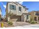 Tan two-story house with green shutters and a neatly landscaped yard at 1934 Karner Blue Ave, North Las Vegas, NV 89031